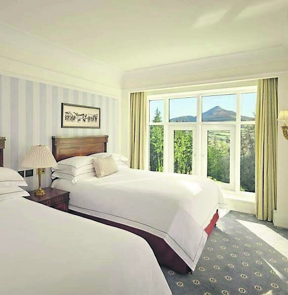 A bed in the Mountain View suite of the Powerscourt Hotel