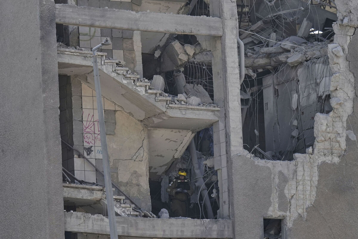 Israeli emergency teams work in an unpopulated building after it was hit by a missile fired from Iran, in Haifa, Israel, Friday, June 20, 2025. Picture: AP Photo/Baz Ratner