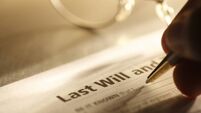 Man signing last will and testament