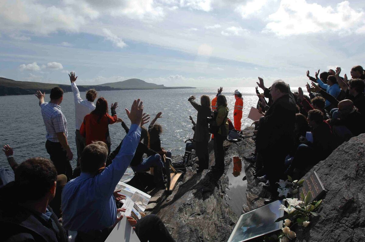 Locals and climbers, family and friends of climber free soloist Michael Reardon US waving at the memorial service on Valentia Island for climber Michael Reardon in 2007. Picture: Don MacMonagle