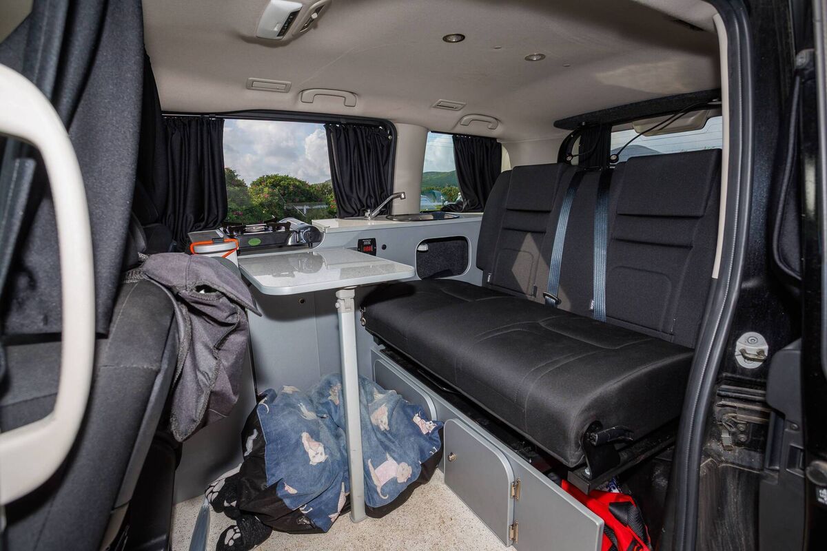 The rear acts as a dining and living space, and converts to a bedroom.