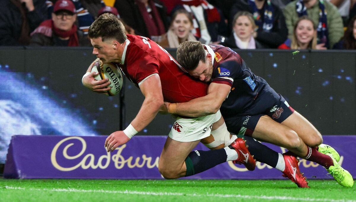 Huw Jones of the Lions scores his side's seventh try despite the attempted tackle from Lachie Anderson of the Queensland Reds. Pic: Steve Christo/Sportsfile