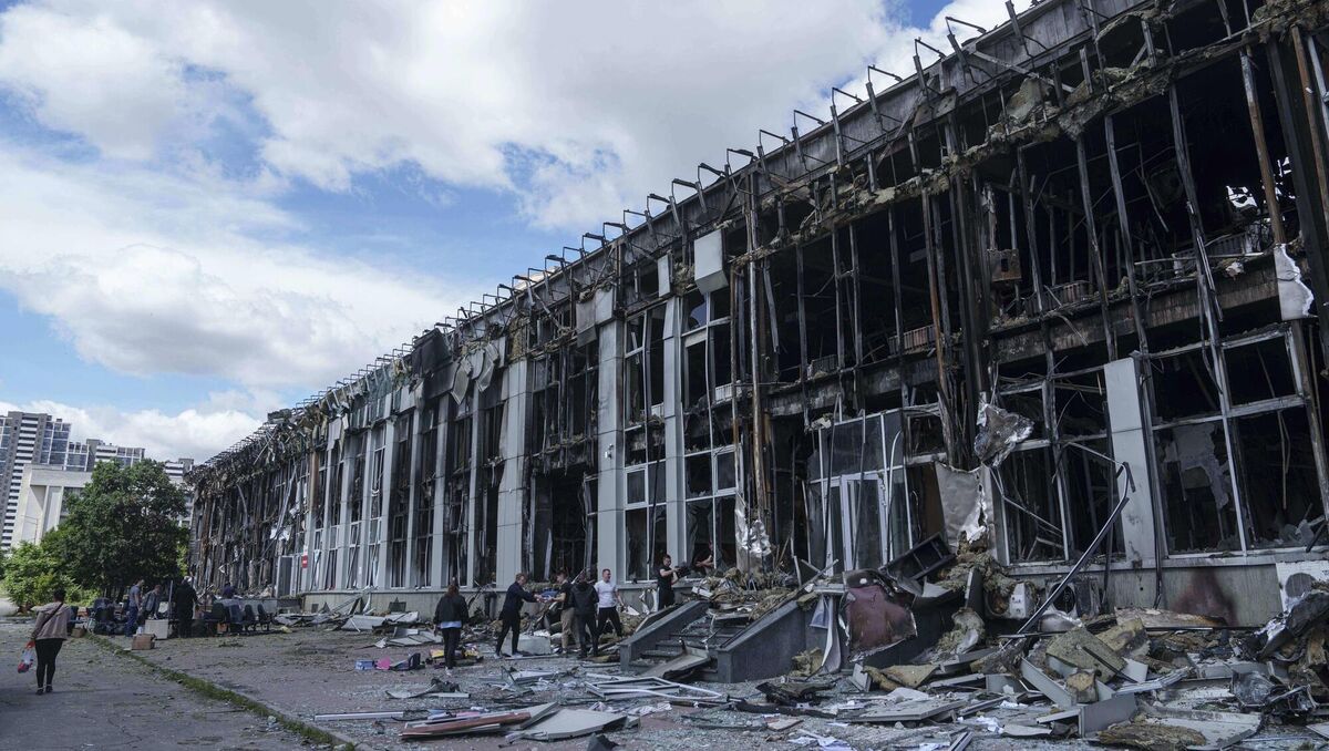 People move properties from an office building destroyed by a Russian strike in Kyiv, Ukraine, last month. Picture: Evgeniy Maloletka/ AP