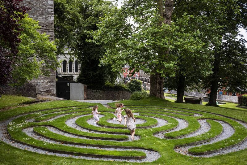 Laura Sullivan (6, Glanmire), Olivia Phillips (6, Youghal) and Isabel Phillips (3, Youghal), having fun in the labyrinth, a hidden gem on the grounds of St Fin Barres Cathedral, one of the many attractions on the new Cork City Playful Culture Trail. 