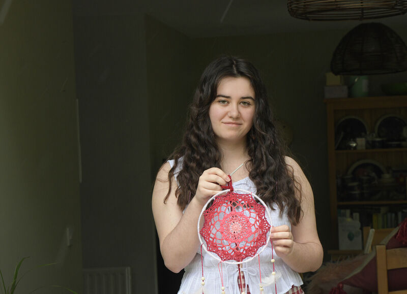  Holly Browne with a suncatcher, which she is crocheting. Photograph Moya Nolan.