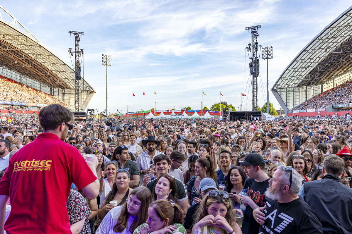 Event staff handing out water to fans to help cool them down as temperatures soared in Thomond Park. Event staff handing out water to fans to help cool them down as temperatures soared in Thomond Park.