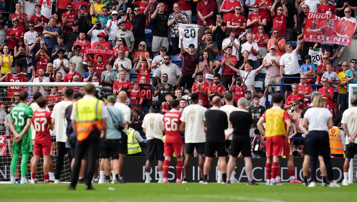 Liverpool fans pay tribute to Diogo Jota as the players watch on following the pre-season friendly at Preston (Martin Rickett/PA)