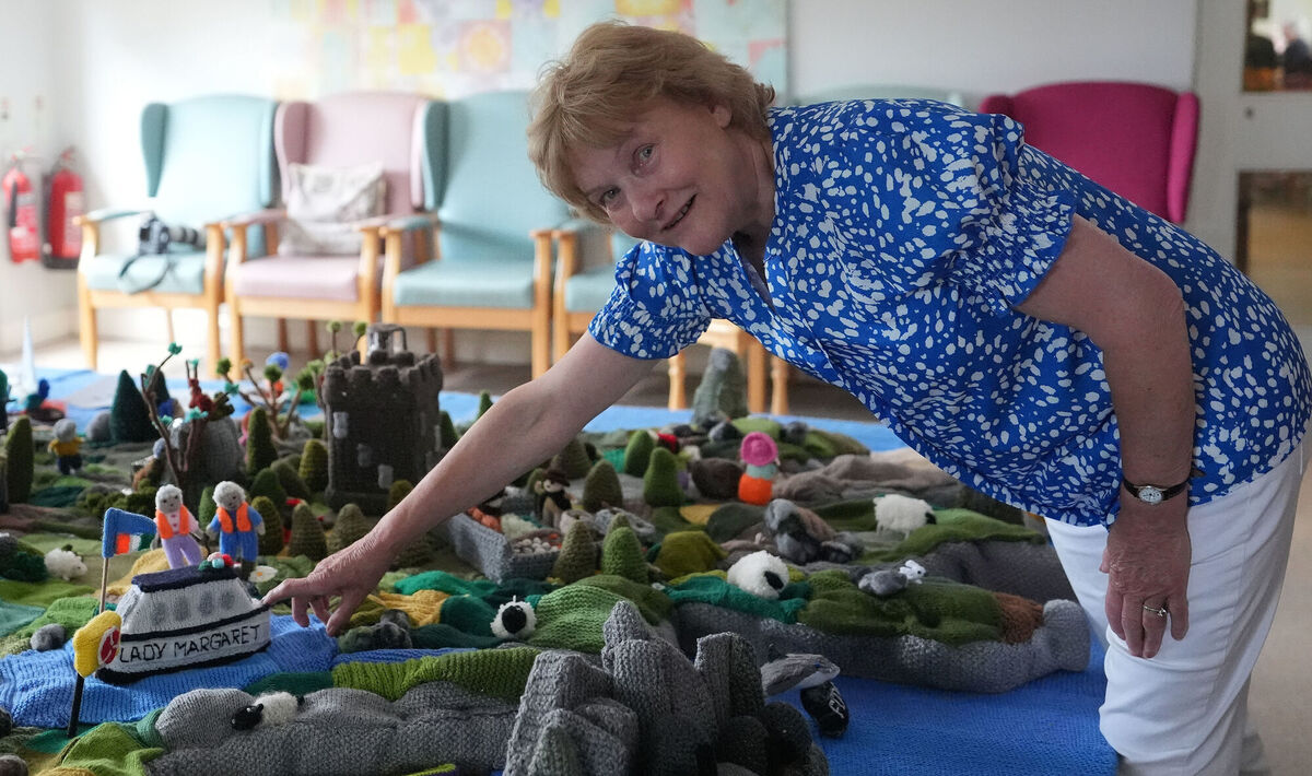 Mary Blake points to a boat in memory of Margaret Dowse who passed away during the creation of her group's knitted map of Ireland. Picture: Niall Carson/PA Wire