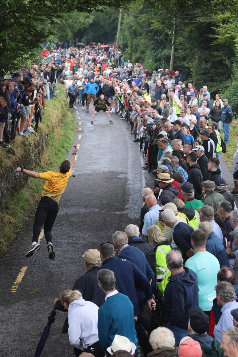 THROUGH THE MILLING CROWDS: Armagh's Ethan Rafferty - better known as the county's No 1 - contesting (and winning) the All-Ireland Senior Road Bowling Championships at Castletownkenneigh in Co Cork. This decisive moment, brilliantly captured by Greta Cormican, is his throw from 'The Black Gate' to 'Fehilly’s Lane' and was critical in ensuring Rafferty went out to Forshin's Cross in one more. That and his following throw made it virtually impossible for final opponent Arthur McDonagh to mount a successful comeback. Pic: Greta Cormican