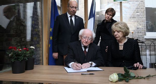 President Higgins signs book of condolence after minute's silence for Paris attack victims