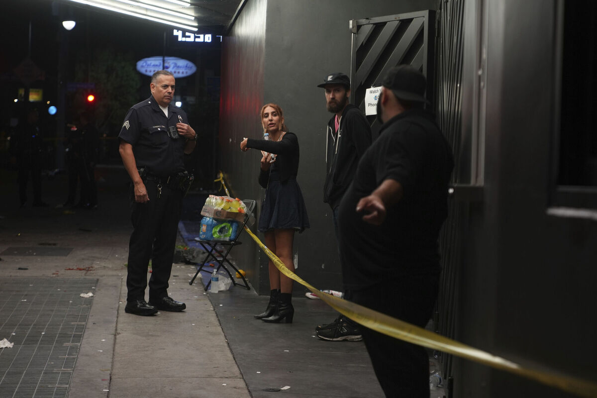 Los Angeles Police officers interview people inside a nightclub after a vehicle rammed into a crowd gathered outside "The Vermont" nightclub in Los Angeles, early morning Saturday, July 19, 2025. (AP Photo/Damian Dovarganes)