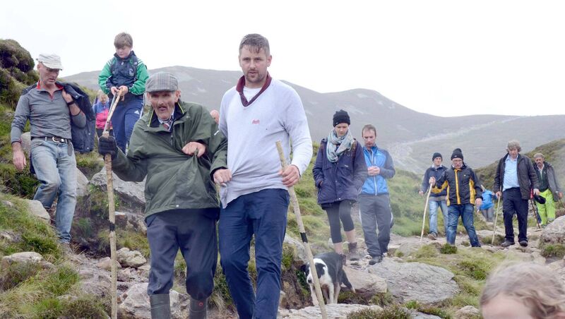 78-year-old John Finneran has climbed the mountain every year for the last 61 years, being helped down the mountain by his son Tony. File Picture: Paul Mealey