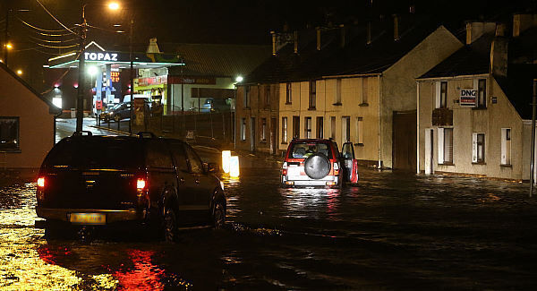 People make their way though floods in the Castlefin area of Donegal. Pic: PA
