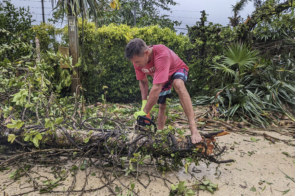 A man uses a chainsaw on a fallen tree in Port Vila, Vanuatu, in 2023 after a cyclone barreled through the Pacific island nation. The International Court of Justice case was instigated by law students at the University of the South Pacific in Vanuatu in 2019. File photo: Matt Hardwick/Australian Broadcasting Corp. via AP