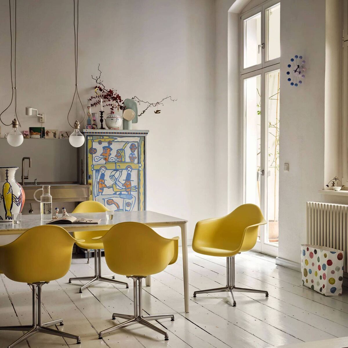 This kitchen throws away every expectation with its metal sink unit and painted larder cabinet. Look closer and you can see that its user friendly for a swat with a mop below the sink and table. Secured to the wall is a dirt-defying up-stand. Styling by Vitra.