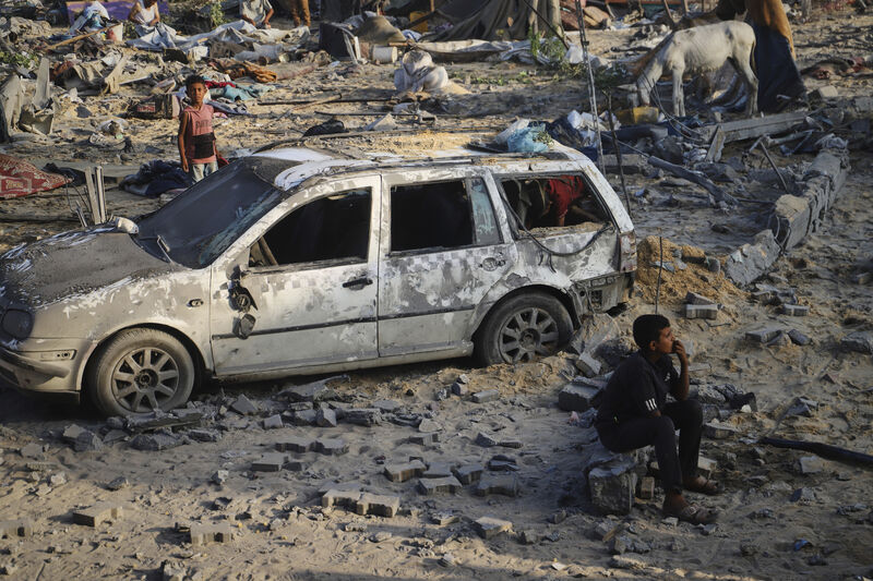 Palestinians inspect the site struck by an Israeli bombardment in Muwasi, Khan Younis, Gaza Strip, Monday, July 28, 2025. (AP Photo/Mariam Dagga)