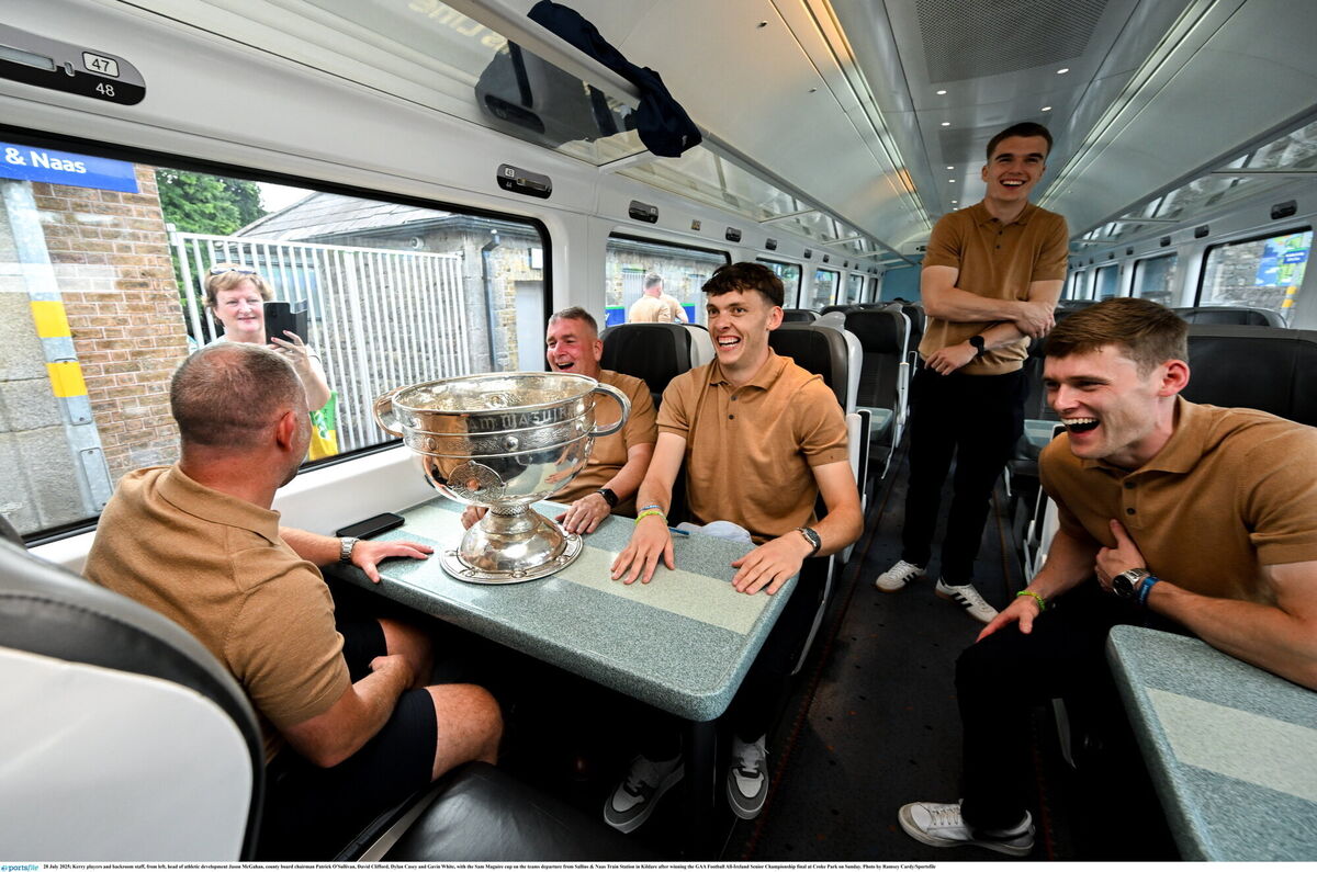 Kerry players and backroom staff, from left, head of athletic development Jason McGahan, county board chairman Patrick O'Sullivan, David Clifford, Dylan Casey and Gavin White, with the Sam Maguire cup on the team's departure from Sallins & Naas Train Station in Kildare. Pic: Ramsey Cardy/Sportsfile Kerry players and backroom staff, from left, head of athletic development Jason McGahan, county board chairman Patrick O'Sullivan, David Clifford, Dylan Casey and Gavin White, with the Sam Maguire cup on the team's departure from Sallins & Naas Train Station in Kildare. Pic: Ramsey Cardy/Sportsfile