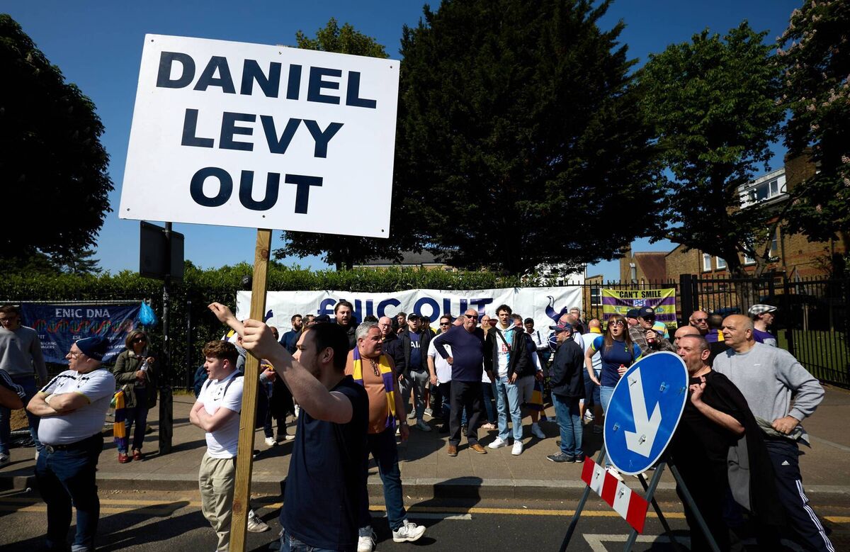 Fans are seen outside the stadium holding a sign reading "Daniel Levy Out" prior to a Premier League match. Pic: Julian Finney/Getty Images.
