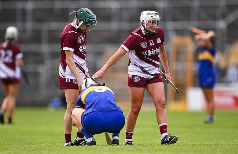 Ailish O'Reilly, right, and Niamh Mallon of Galway console Caoimhe McCarthy of Tipperary after the Glen Dimplex All-Ireland Camogie Senior Championship semi-final at UPMC Nowlan Park. Pic: Ben McShane/Sportsfile