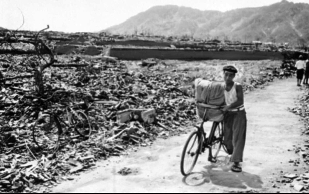 A Japanese man pushes his loaded bicycle down a path that had been cleared of rubble after the atomic bombing of Nagasaki on August 9, 1945. File photo: AP A Japanese man pushes his loaded bicycle down a path that had been cleared of rubble after the atomic bombing of Nagasaki on August 9, 1945. File photo: AP