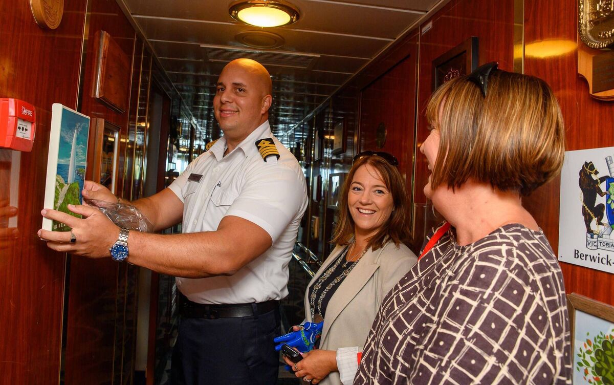 Captain Jose Fonseca of the Island Sky cruise liner was presented with a picture of the Baltimore beacon by councillor Caroline Cronin and Cork County Council senior executive officer Noreen O’Mahony. Picture: John Allen