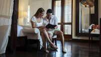 Couple reading a guide in a hotel room