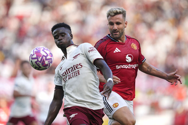 Arsenal's Bukayo Saka (left) and Manchester United's Luke Shaw battle for the ball. Pic: Nick Potts/PA Wire. Arsenal's Bukayo Saka (left) and Manchester United's Luke Shaw battle for the ball. Pic: Nick Potts/PA Wire.