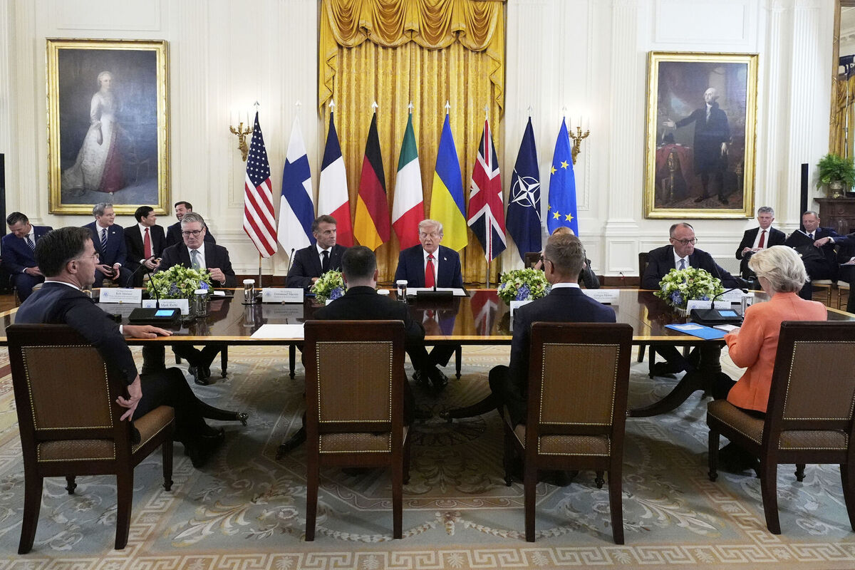 President Donald Trump, seated center, speaks during a meeting with British Prime Minister Keir Starmer, seated from left, France's President Emmanuel Macron and Germany's Chancellor Friedrich Merz in the East Room of the White House, Monday, Aug. 18, 2025, in Washington. (AP Photo/Alex Brandon)