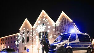 FILE – A police officer guards a blocked road near a Christmas market (Ebrahim Noroozi/AP)