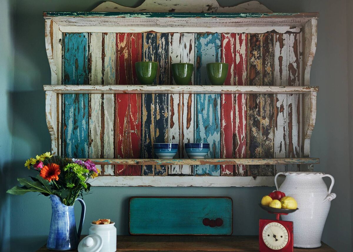 A very old European pine plate rack is left largely “in the paint” with some added creative stain, creating an eye-catching artwork in its own right. File picture