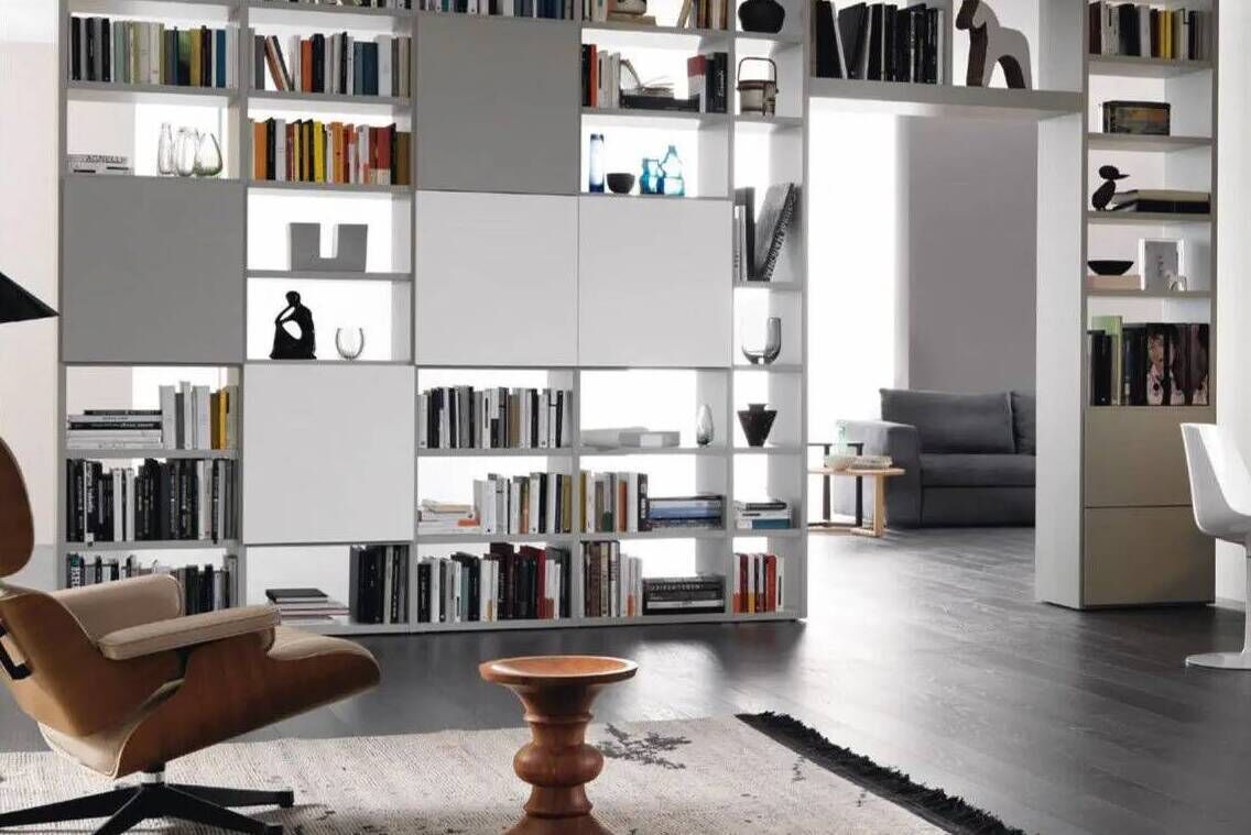 The Sangiacomo freestanding bookshelf provides storage and effective room partitioning.