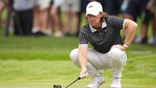 <p>Tommy Fleetwood, of England, lines up his putt on the 17th green. Pic: AP Photo/Mike Stewart</p>
