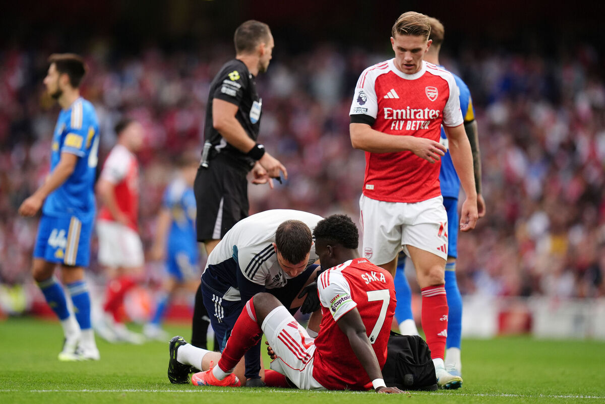 Arsenal's Bukayo Saka is treated by medical staff. Pic: John Walton/PA Wire.