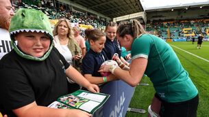 <p>Ireland's Fiona Tuite signs autographs for fans after the game against Japan in the World Cup opener. Picture: Ben Brady/Inpho</p>