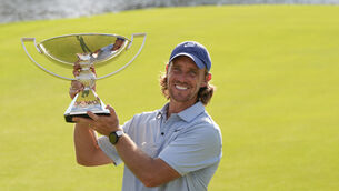 <p>Tommy Fleetwood, of England, holds the championship trophy. Pic: AP Photo/Mike Stewart</p>