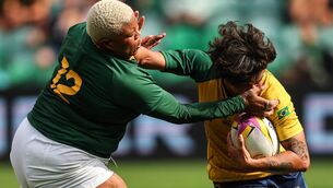 <p>Brazil's Larissa Alves Carvalho fends off to the face Aphiwe Ngwevu of South Africa. Pic: ©INPHO/Ben Brady</p>