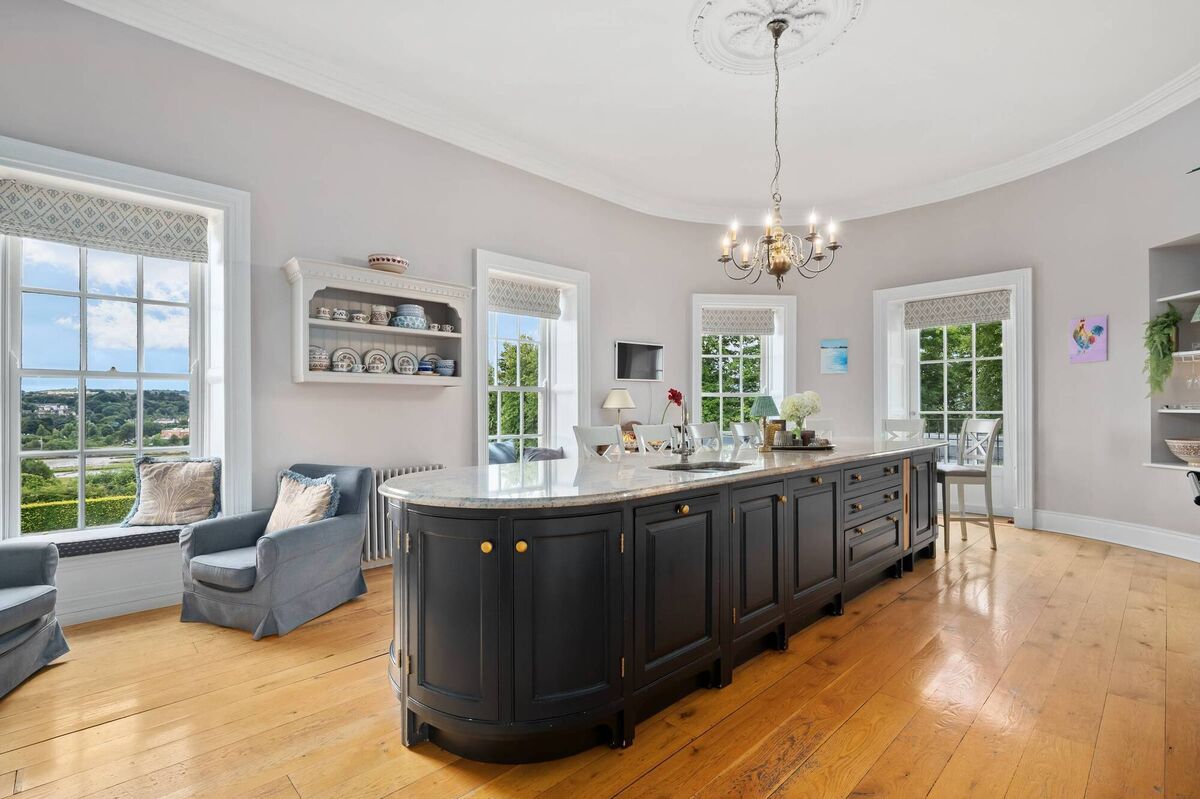 Marble topped island is 16' long in resituated kitchen Marble topped island is 16' long in resituated kitchen