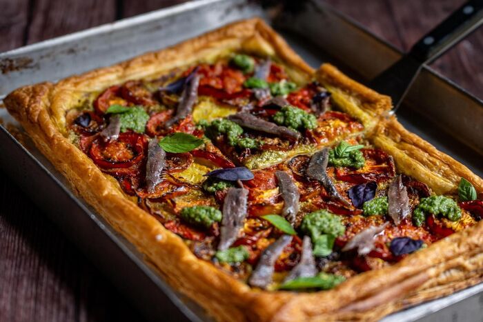 Tomato and anchovy tart with pistachio pesto