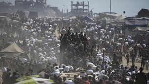 <p>Palestinians carry sacks of flour taken from a humanitarian aid convoy en route to Gaza City, in the outskirts of Beit Lahiya, northern Gaza Strip. Pic: AP Photo/Jehad Alshrafi</p>