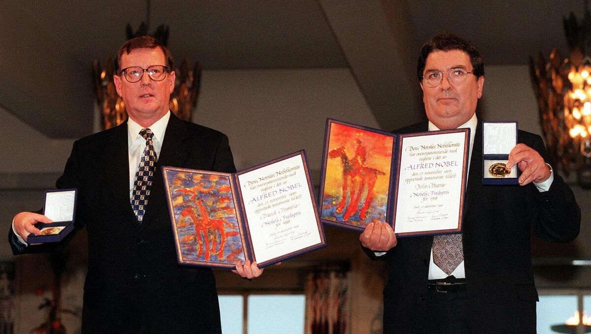 The 1998 Nobel Peace Prize laureates David Trimble and John Hume, displaying the diplomas and medals they received during the awarding ceremony in Oslo.