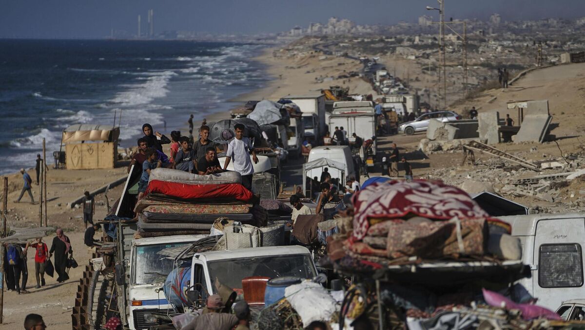 Displaced Palestinians fleeing northern Gaza carry their belongings along the coastal road toward southern Gaza, on Tuesday. Picture: AP