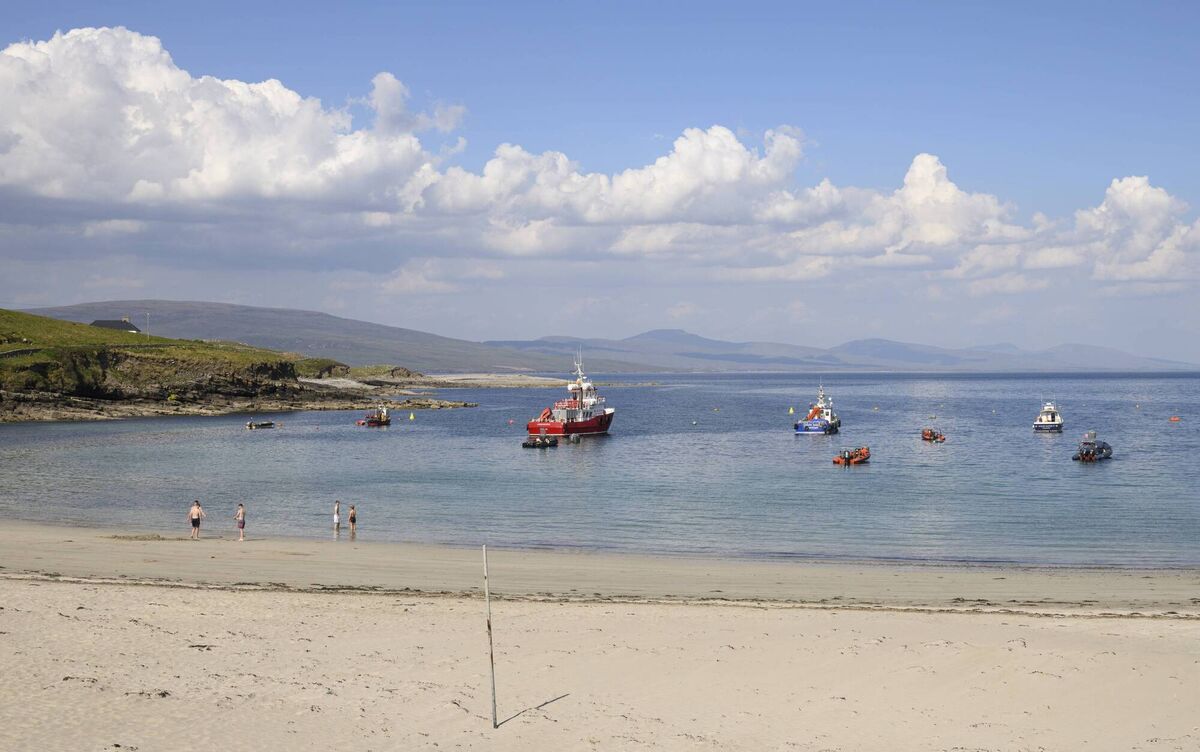 Clare Island’s Blue Flag beach sits beside the harbour, offering soft sand, moored boats, and panoramic views under a clear blue sky. This well-kept beach is home to local wildlife and features a volleyball net, picnic area, and convenient access to public toilets at the nearby community centre. It’s a vibrant yet peaceful spot where locals and visitors gather to relax, swim, and soak in the spirit of the island. 