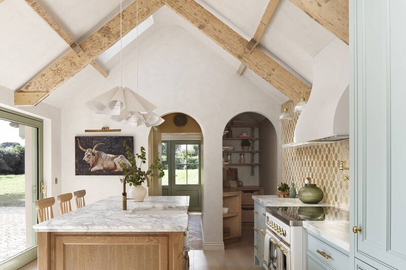 The bright cottage kitchen with exposed beams. 