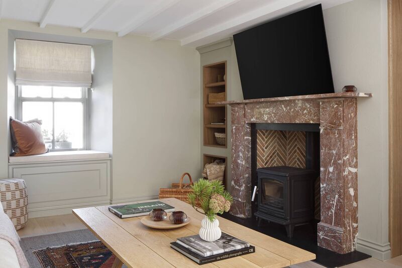 The antique rose pink fireplace in the he living area is one of the cottage's prominent features.
