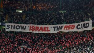 <p>Fans of Celtic hold up a banner reading SHOW ISRAEL THE RED CARD in solidarity with Palestine during a Champions League tie at Celtic Park in February (Photo by Ian MacNicol/Getty Images)</p>