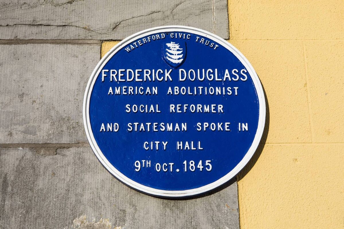 A blue plaque on the exterior of City Hall in Waterford, marking the location where American abolitionist and statesman Frederick Douglass once spoke in 1845. 