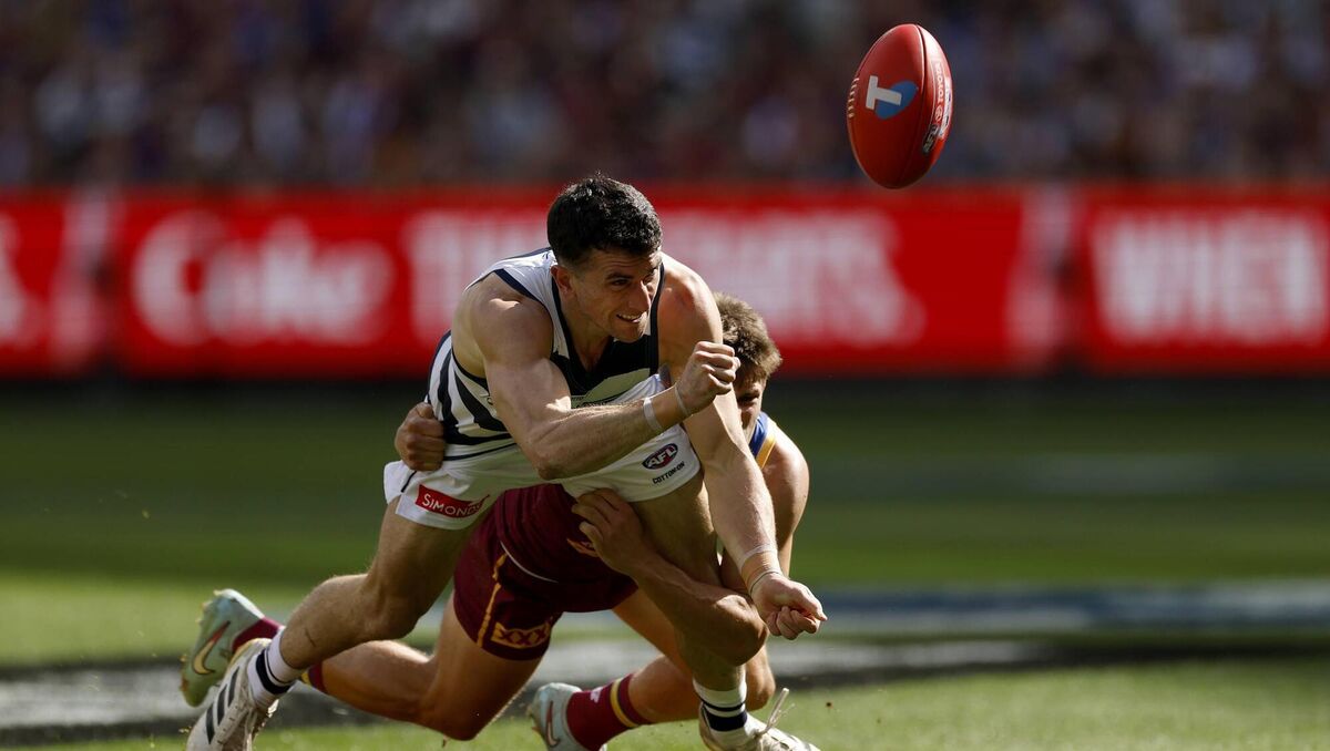 AWAY: Mark O'Connor of the Cats is tackled during the AFL Grand Final at the MCG