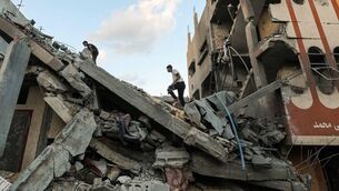 <p>Palestinians check the rubble of a building hit by an Israeli strike in the Nuseirat refugee camp in the central Gaza Strip, on Friday September 25. Picture: Eyad Baba/AFP via Getty Images</p>