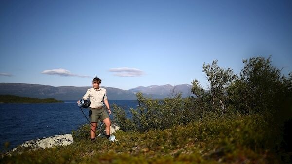 ABOVE: Kathryn Bennett rows across a lake at a research post at Stordalen Mire near Abisko, Sweden. BELOW: Nina Lindstrom Friggens, a researcher at the University of Stirling, measures the rate of carbon dioxide seeping from the soil at Lake Tornetrask near Abisko. Pictures: Hannah McKay/Reuters
