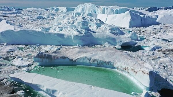 In this aerial view melting ice forms a lake on free-floating ice jammed into the Ilulissat Icefjord during unseasonably warm weather on July 30 near Ilulissat, Greenland.
